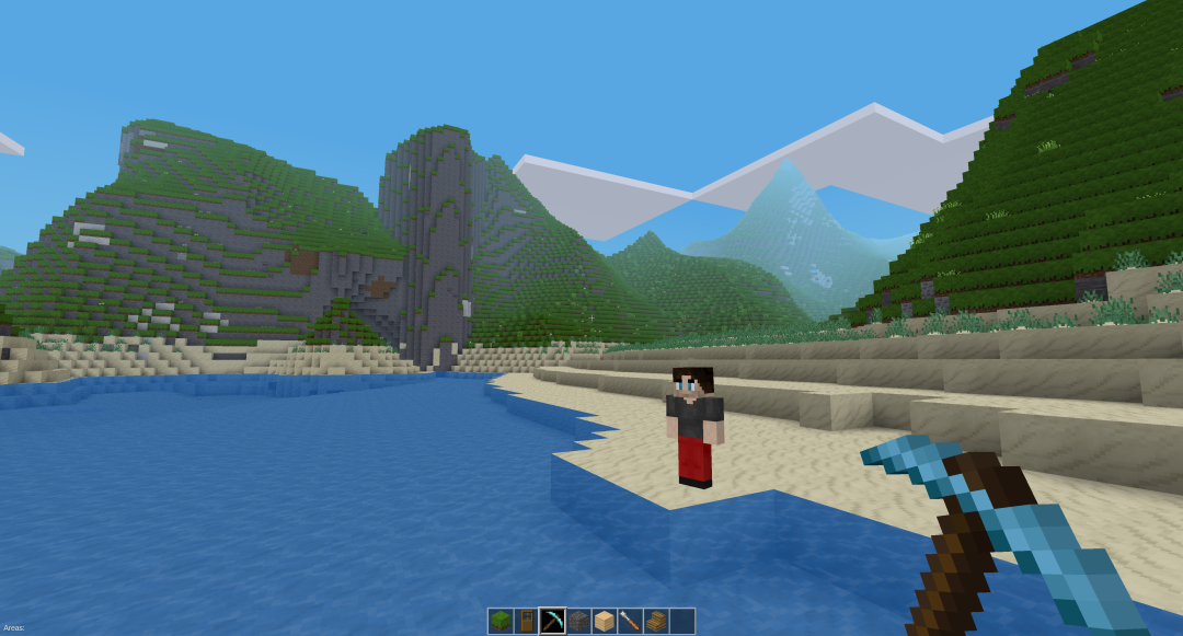 Blockbasierte Computerspielumgebung, in der ein Mensch am Strand vor einer Bergkulisse steht.